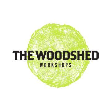 The Woodshed logo with a green tree cookie